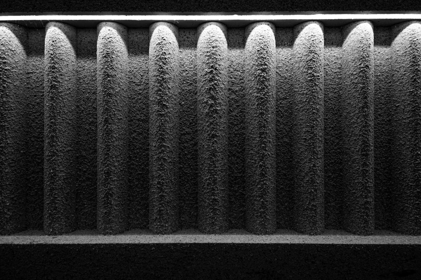 The pleats of an air filter clogged with gray dust.