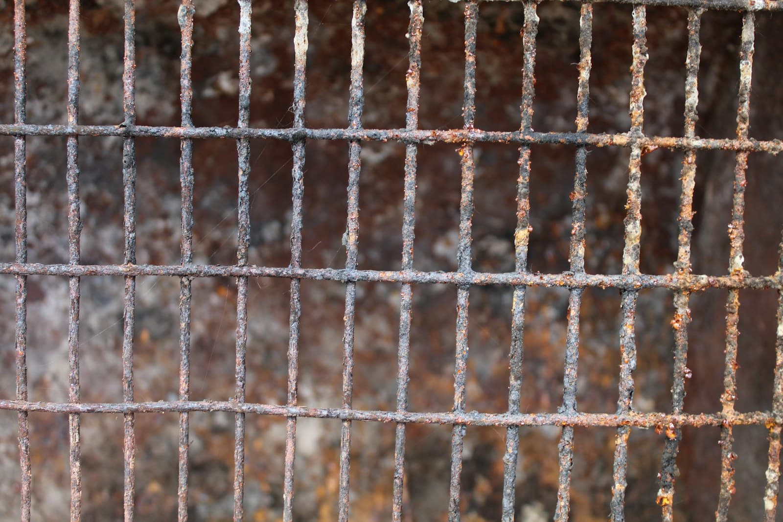 A rusty, grimy grill grate up close.