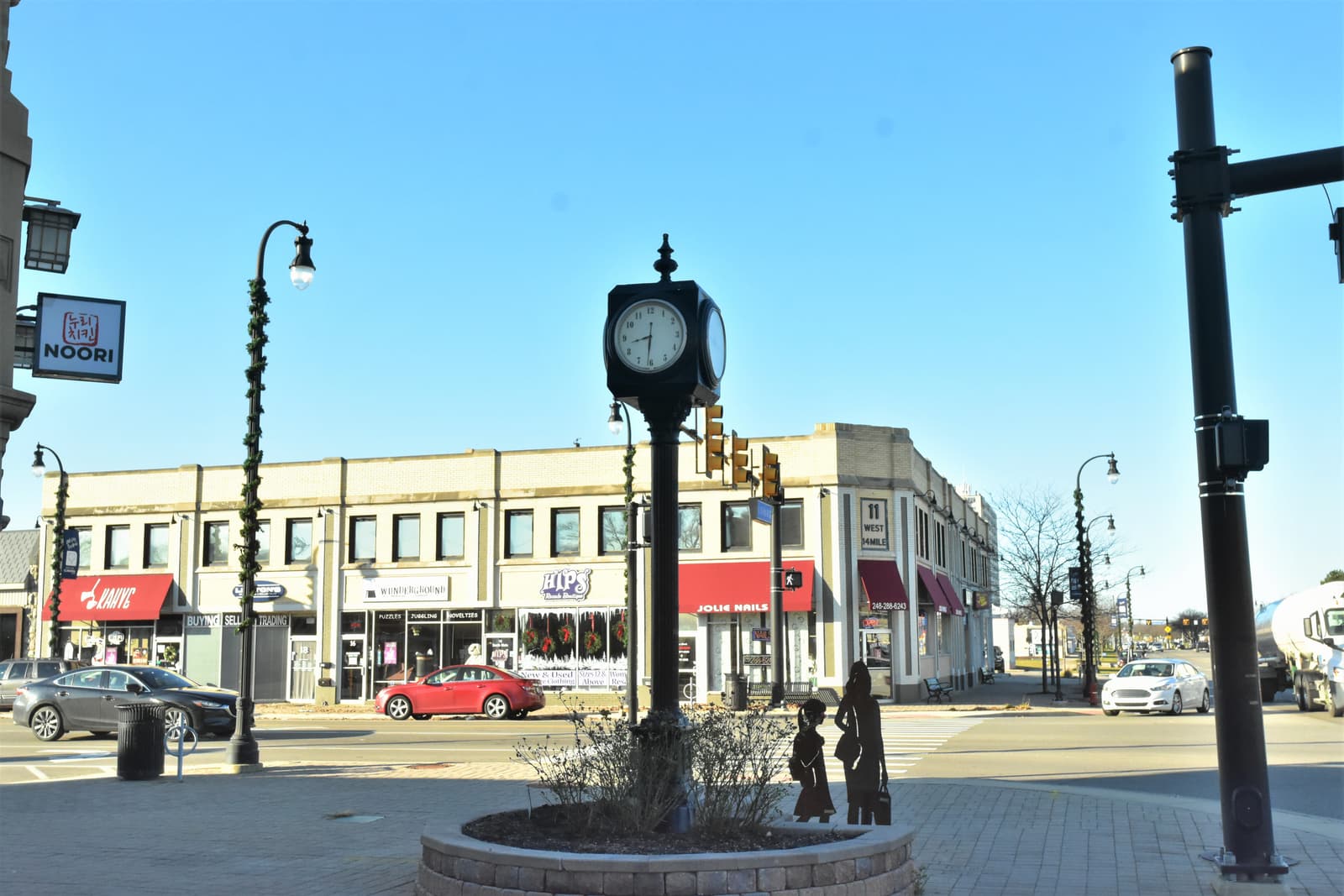 The street clock and storefronts at the main corner of downtown Clawson, Michigan.
