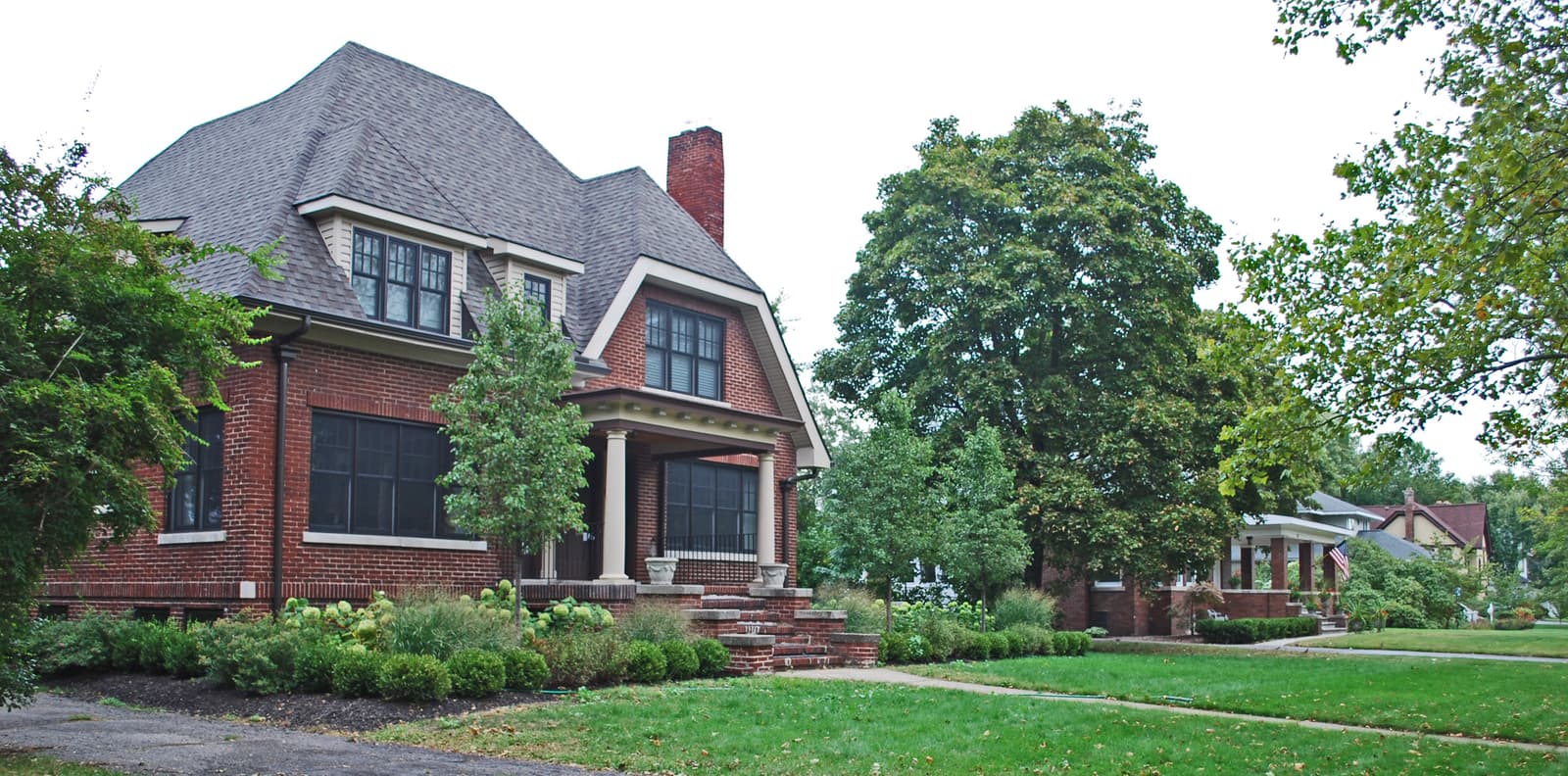 A large brick house with a gambrel roof and dormers in the Pleasant Ridge historic district, Michigan.