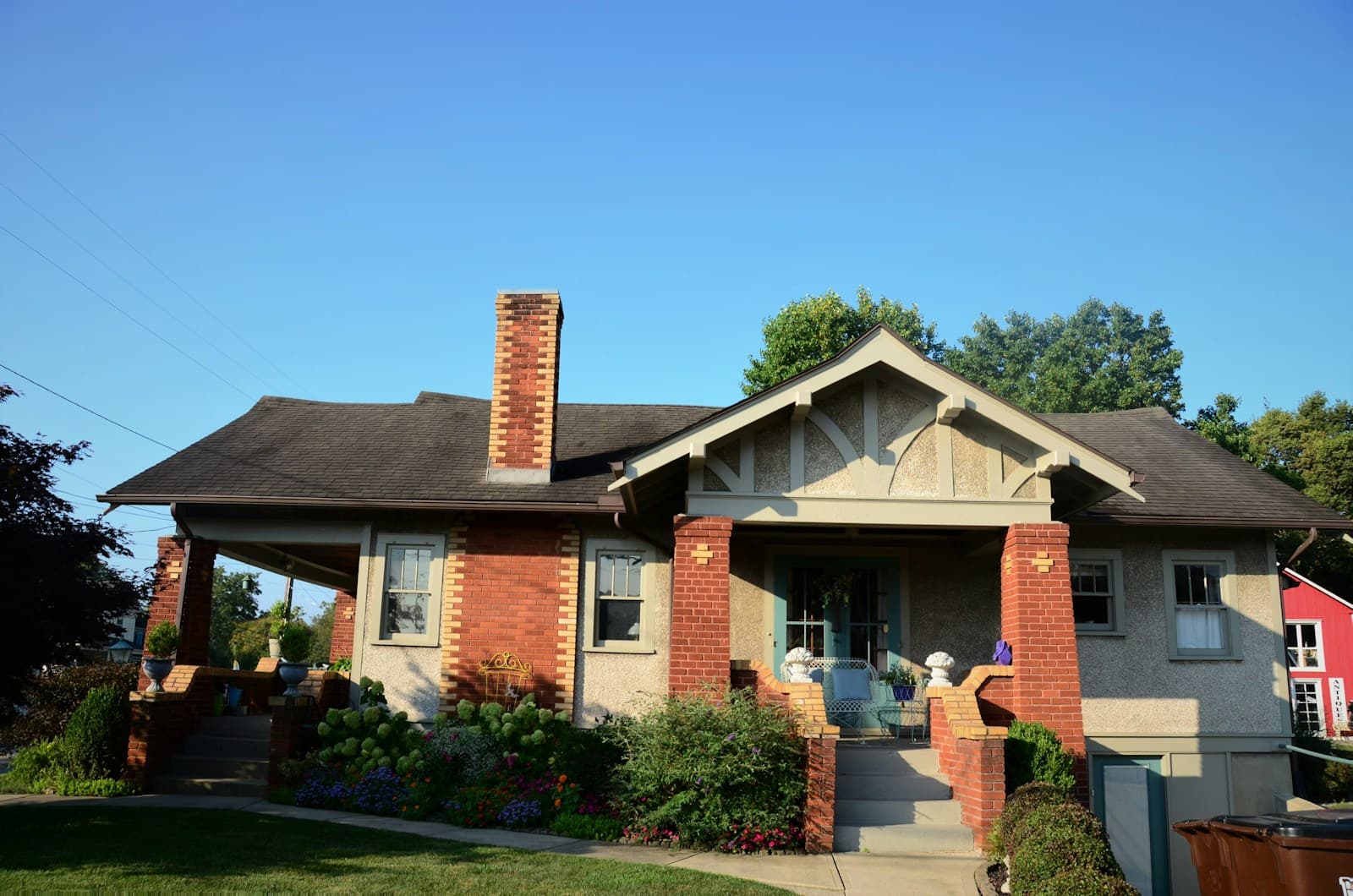 A craftsman bungalow with brick porch piers under a wide front gable.